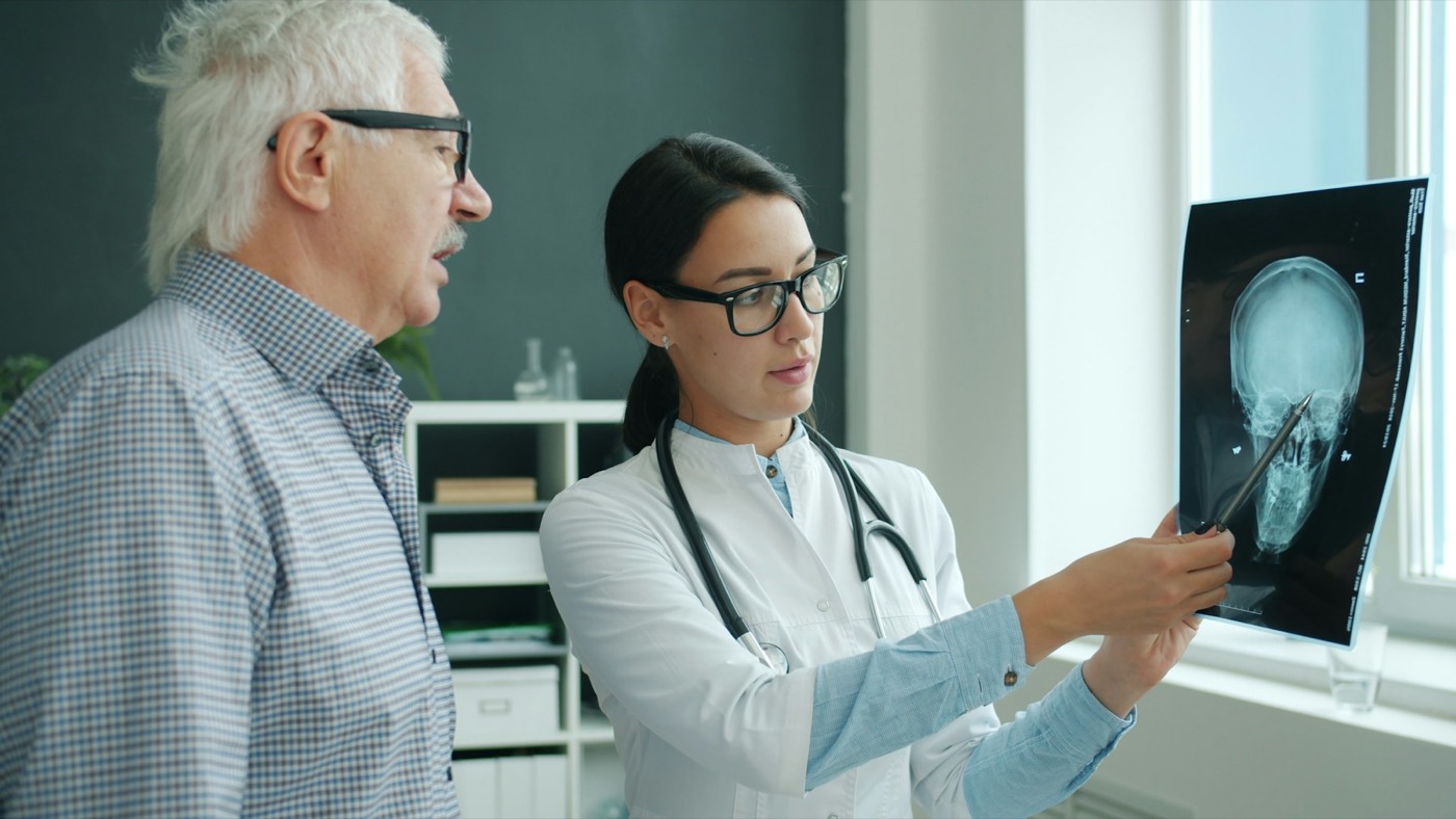 A doctor going over a scan with an older man